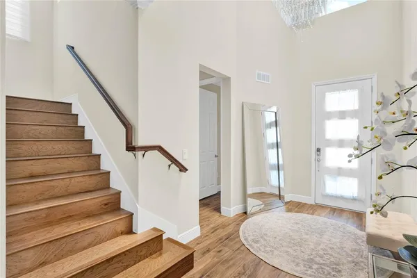 a view of entryway and hall with wooden floor