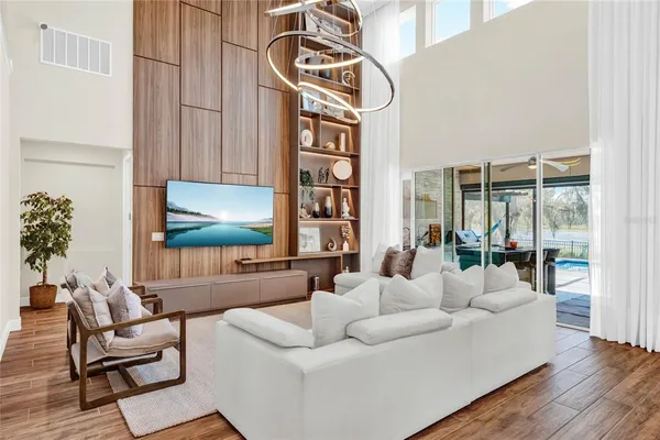 a living room with furniture and a floor to ceiling window
