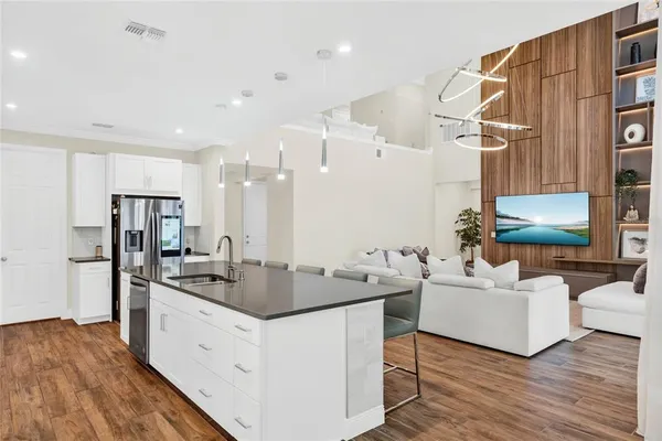 a kitchen with stainless steel appliances granite countertop a sink and a refrigerator