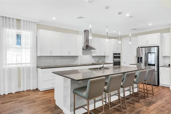 a large kitchen with a table and chairs in it