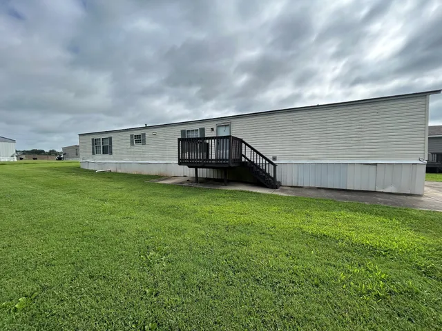 a view of a house with a backyard
