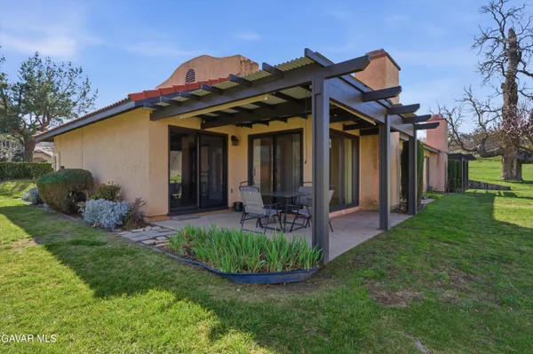 a view of a house with backyard and porch