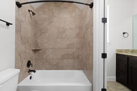 a bathroom with a shower and a toilet