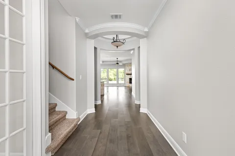 a view of hallway with wooden floor