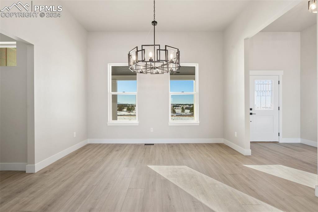 17615 Blacksmith Drive Peyton, CO 80831 - Photo 16 of 41 a view of empty room with wooden floor and window
