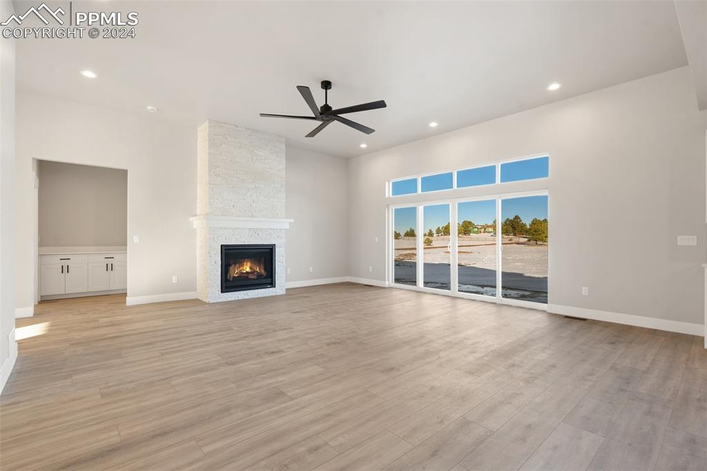 17615 Blacksmith Drive Peyton, CO 80831 - Photo 17 of 41 a view of an empty room with a fireplace and a window