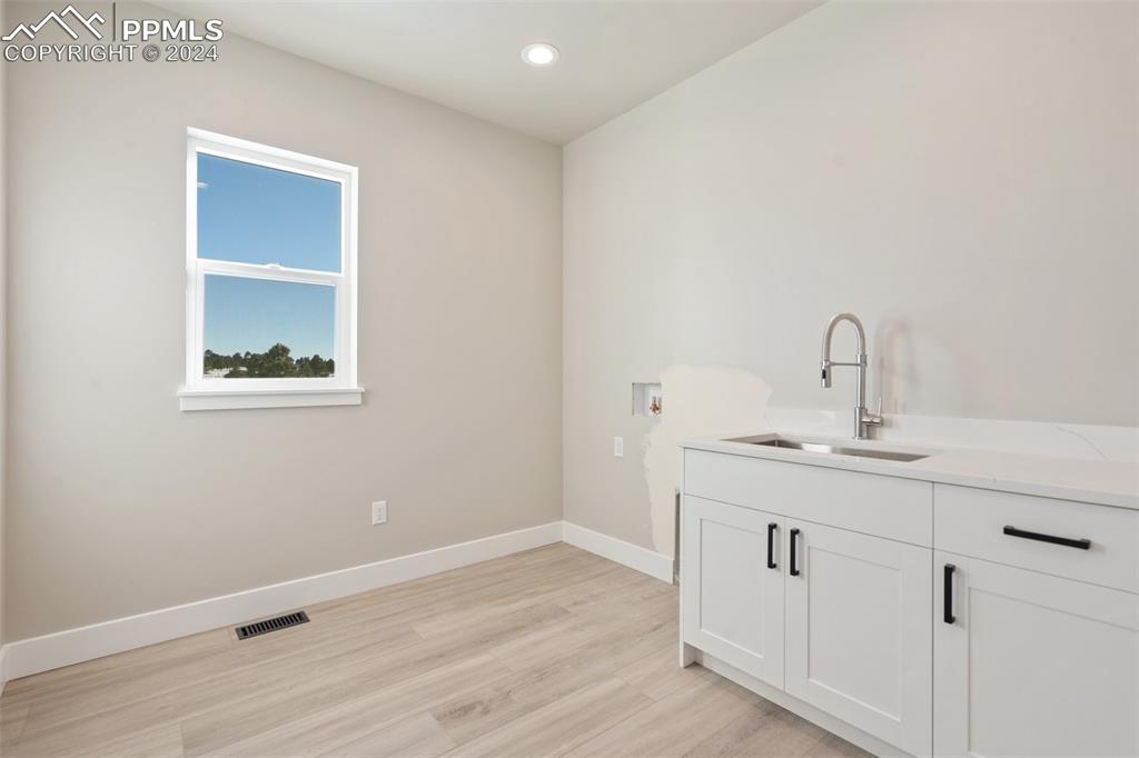 17615 Blacksmith Drive Peyton, CO 80831 - Photo 26 of 41 a bathroom with a sink and a mirror