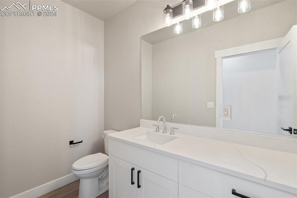17615 Blacksmith Drive Peyton, CO 80831 - Photo 27 of 41 a bathroom with a sink a toilet and a mirror