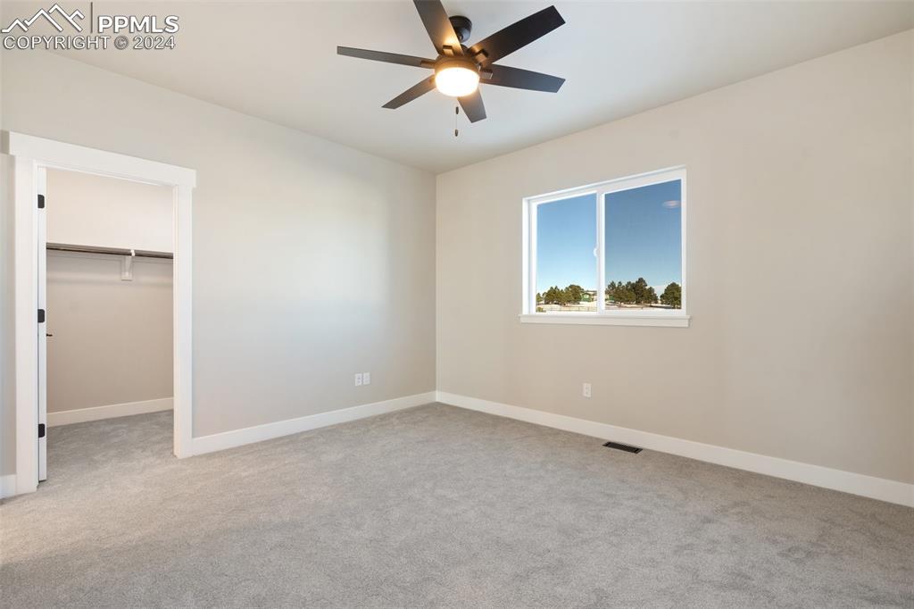 17615 Blacksmith Drive Peyton, CO 80831 - Photo 32 of 41 an empty room with closet and a ceiling fan