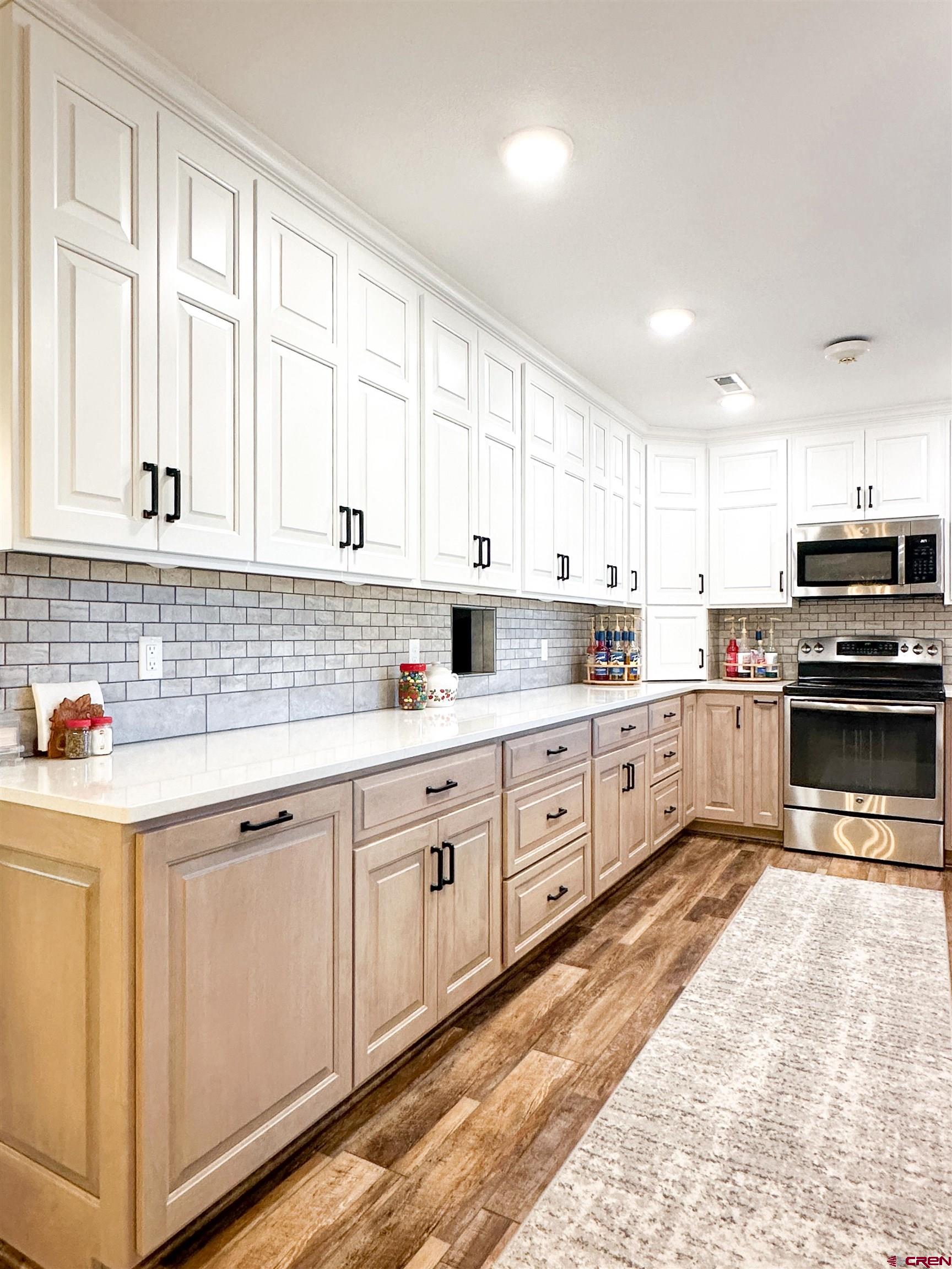 18555 F Road Delta, CO 81416 - Photo 12 of 43 a kitchen with granite countertop white cabinets and white appliances