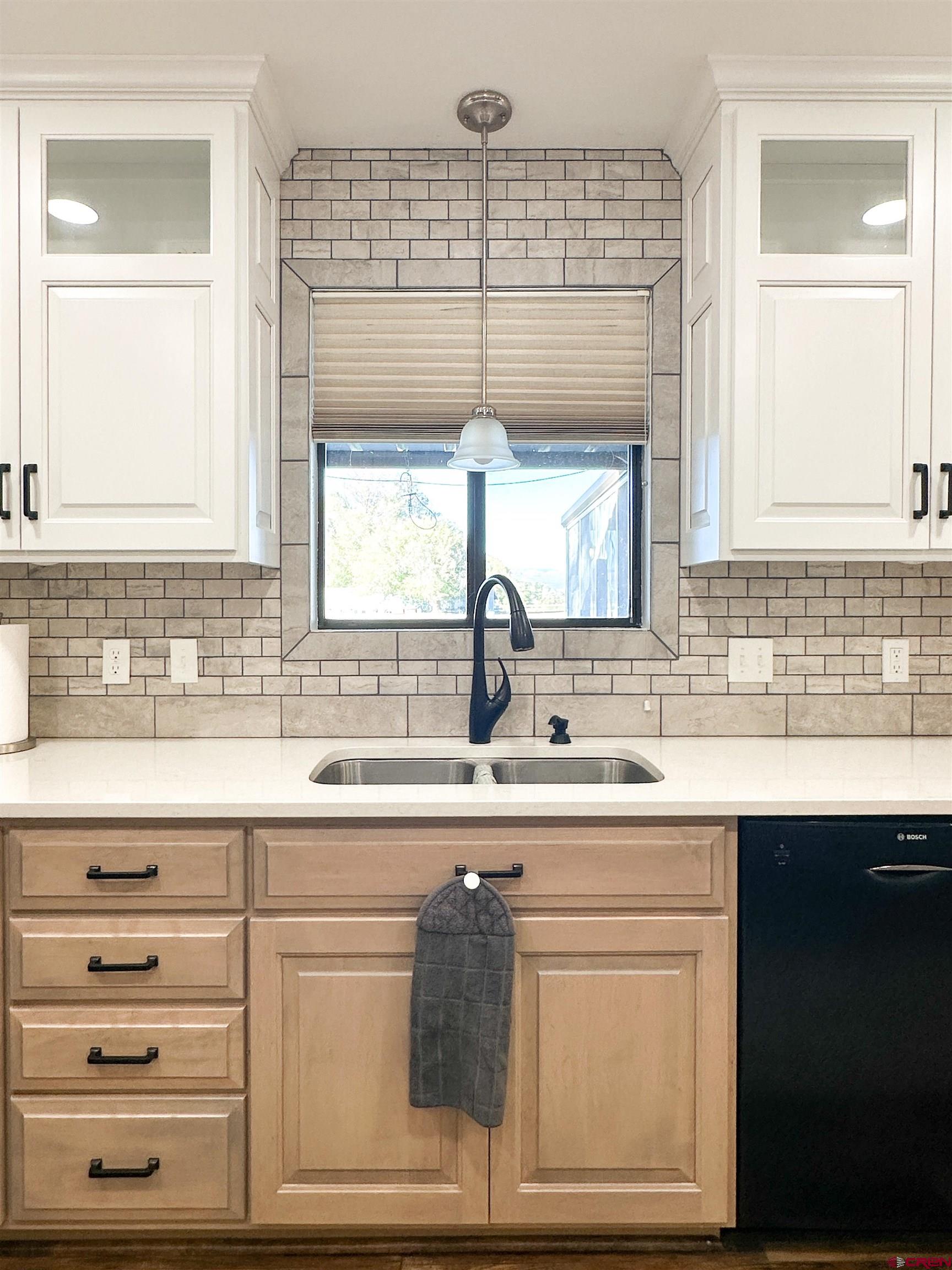 18555 F Road Delta, CO 81416 - Photo 14 of 43 a kitchen with cabinets appliances a sink and a window