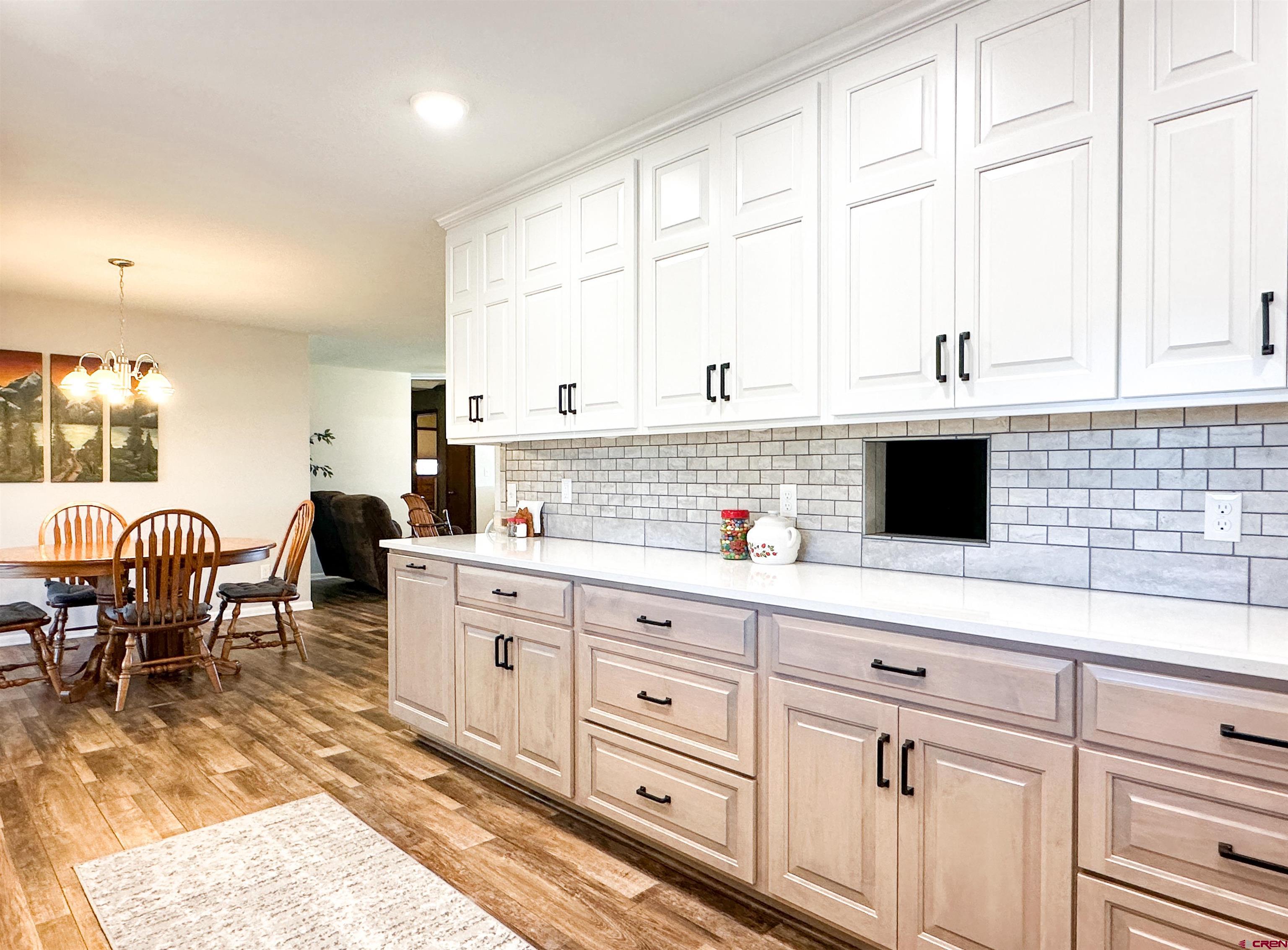 18555 F Road Delta, CO 81416 - Photo 15 of 43 a open kitchen with granite countertop a sink a stove and white cabinets