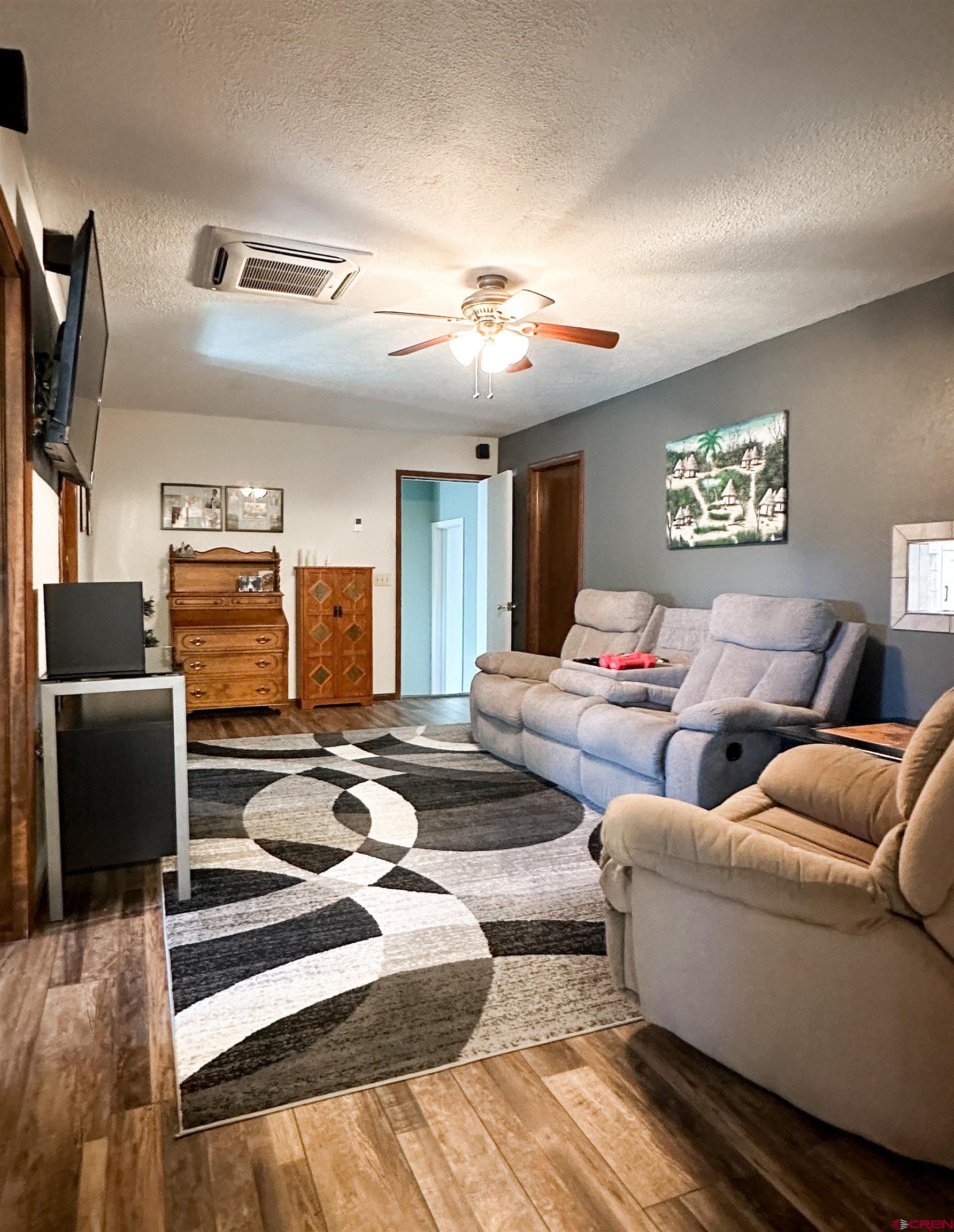 18555 F Road Delta, CO 81416 - Photo 16 of 43 a living room with furniture and a flat screen tv