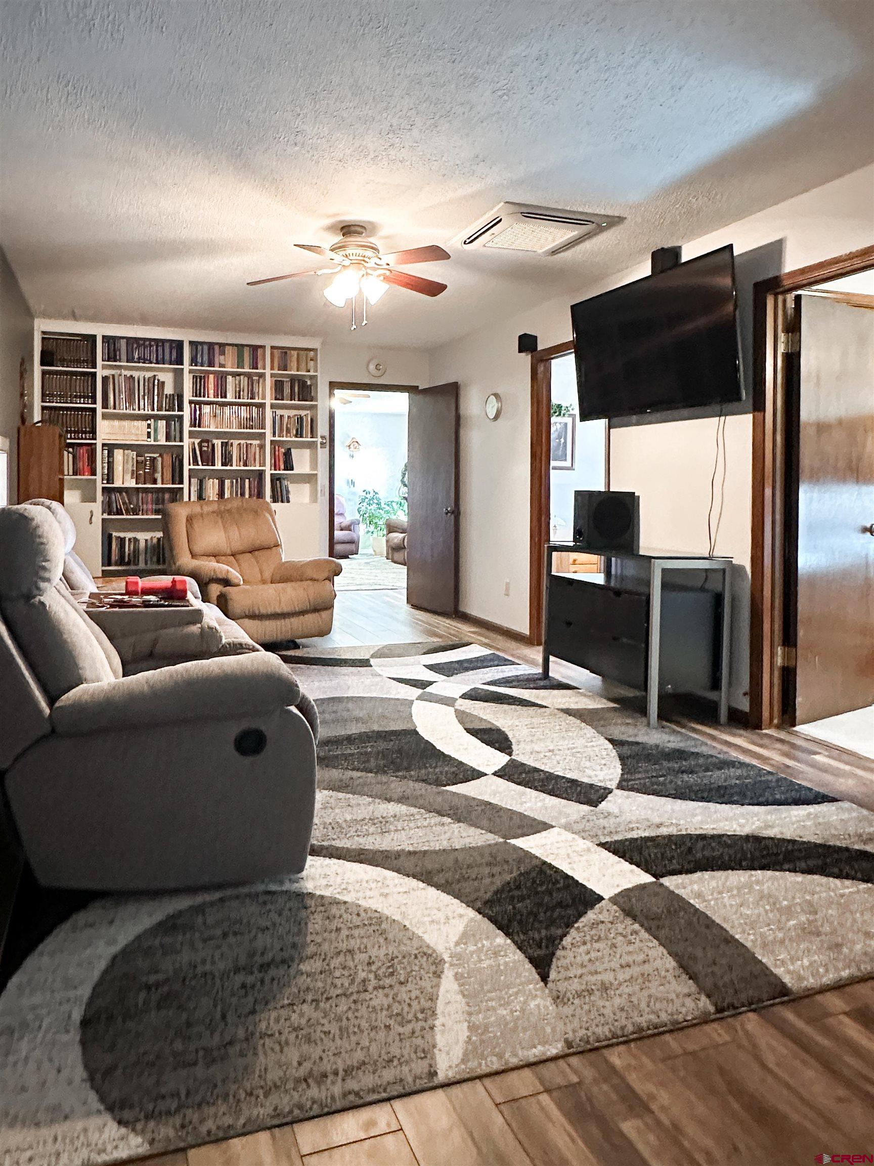 18555 F Road Delta, CO 81416 - Photo 17 of 43 a living room with furniture and a flat screen tv