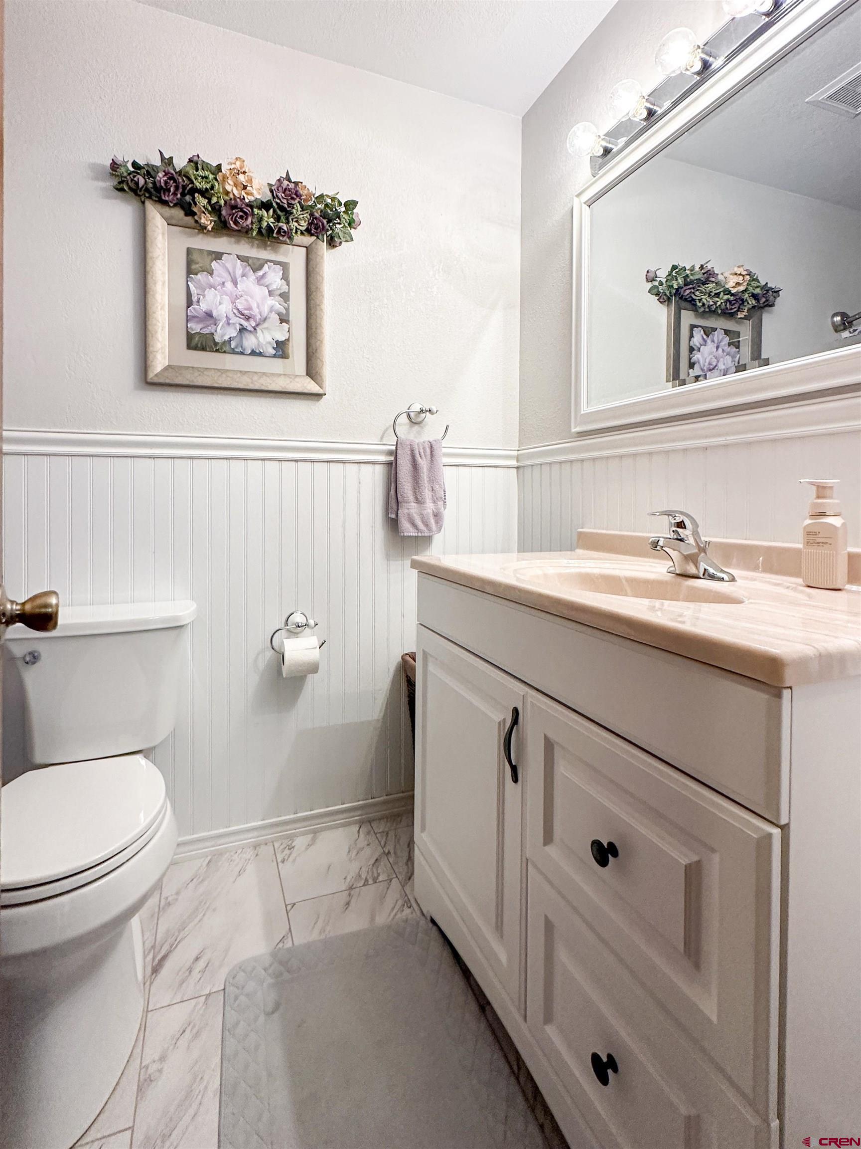 18555 F Road Delta, CO 81416 - Photo 20 of 43 a bathroom with a toilet sink and mirror