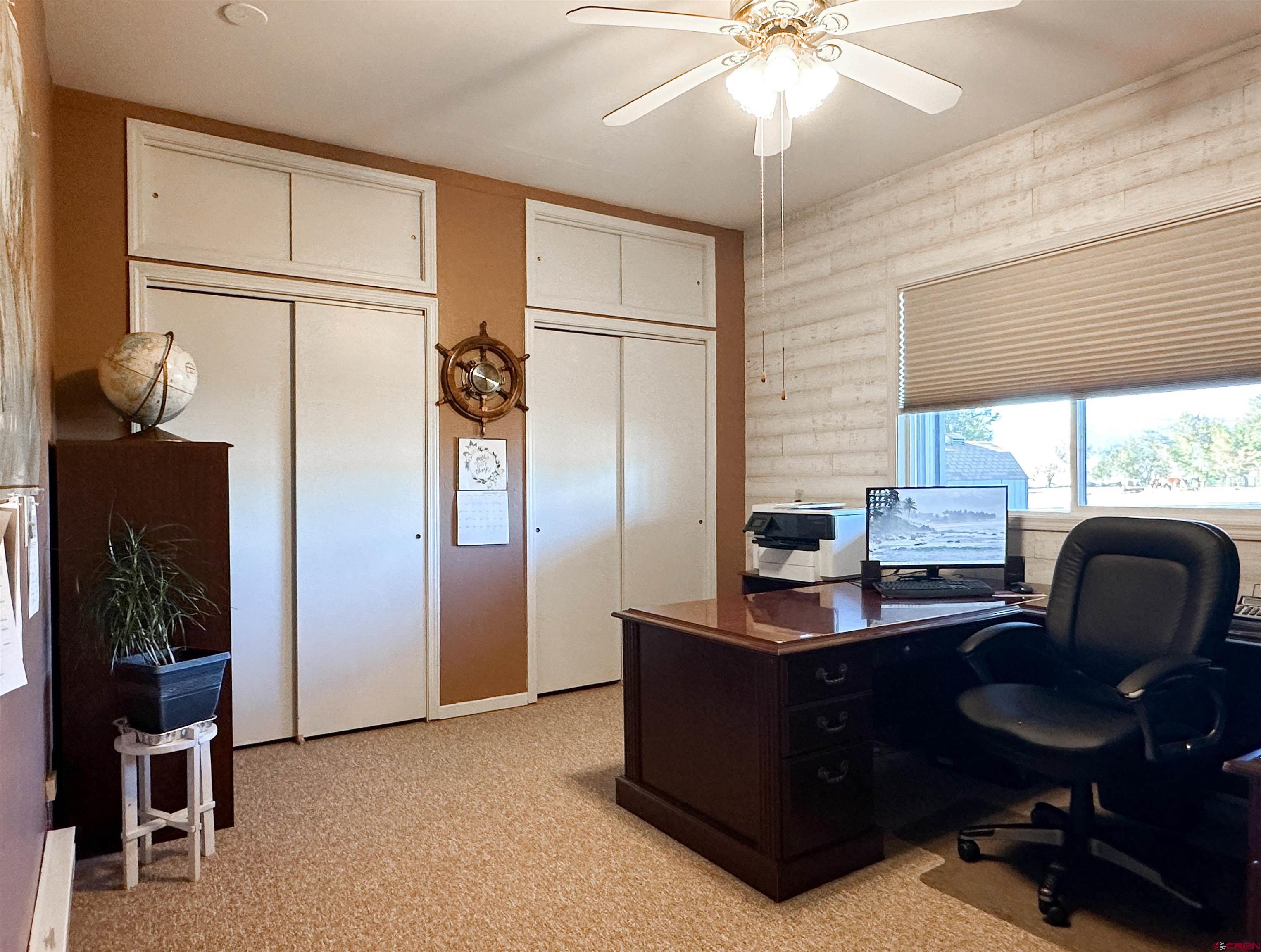 18555 F Road Delta, CO 81416 - Photo 25 of 43 a view of a workspace with furniture and a window