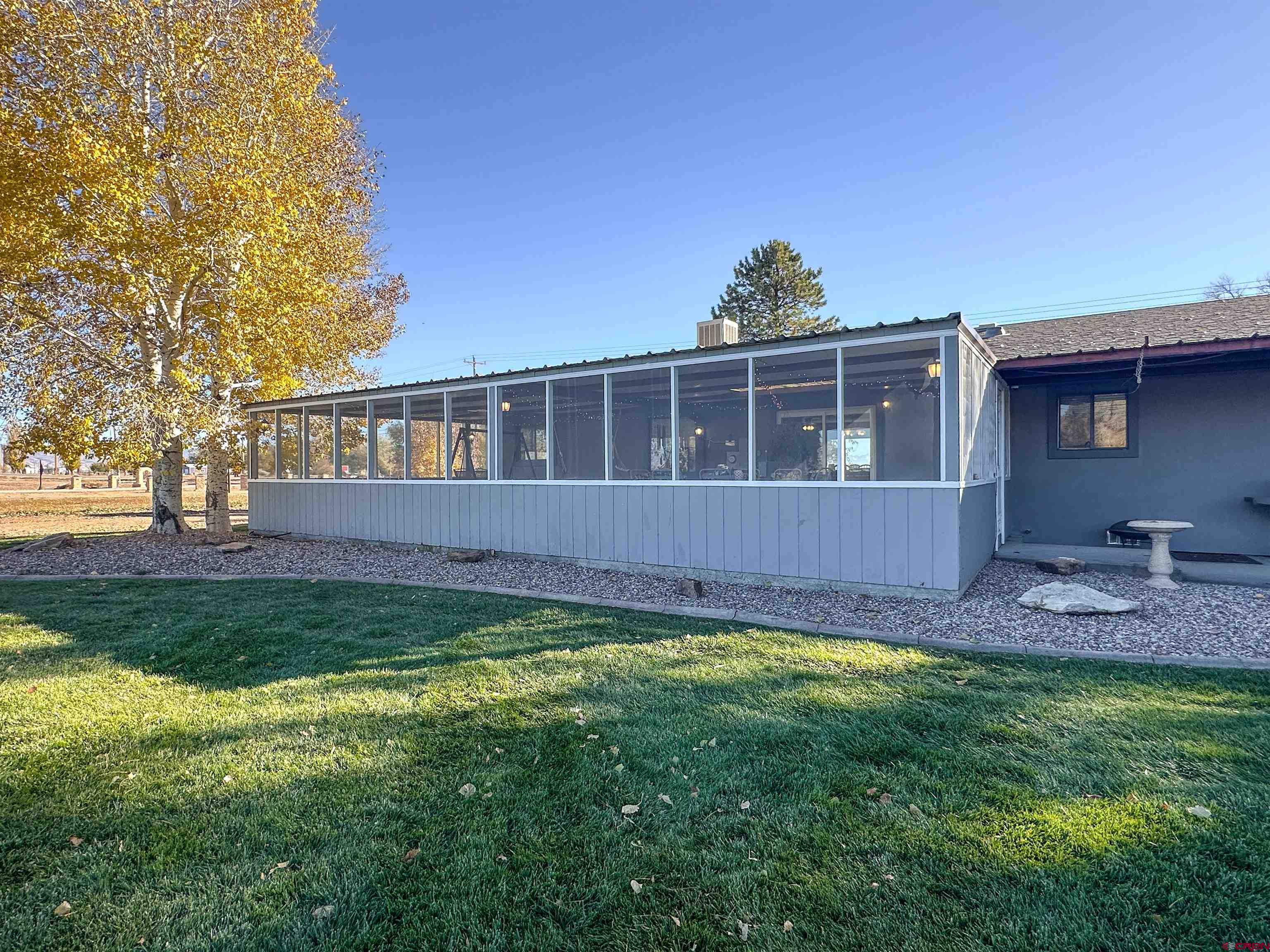 18555 F Road Delta, CO 81416 - Photo 31 of 43 a view of a house with backyard and sitting area