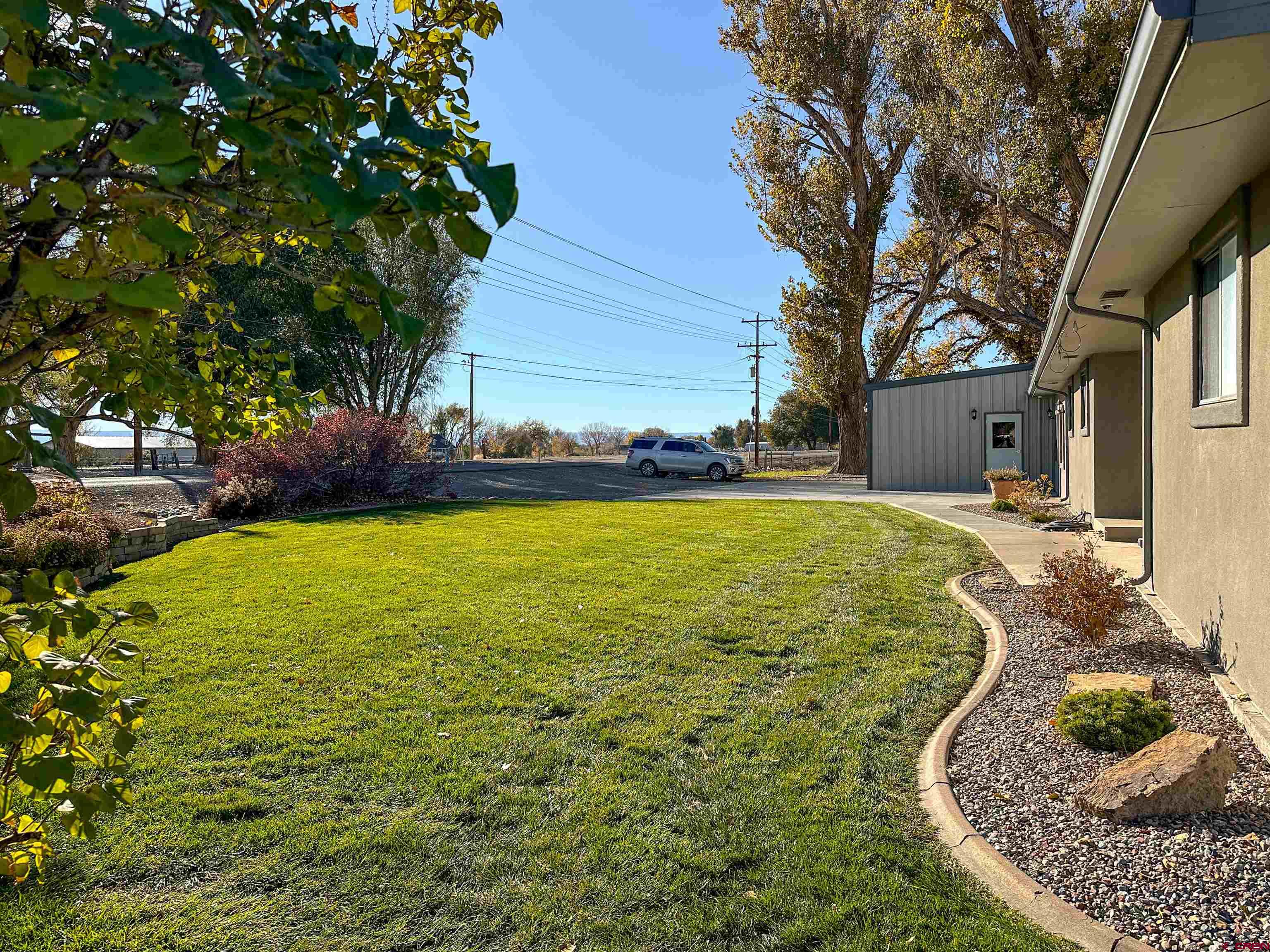 18555 F Road Delta, CO 81416 - Photo 34 of 43 a view of a house with a yard
