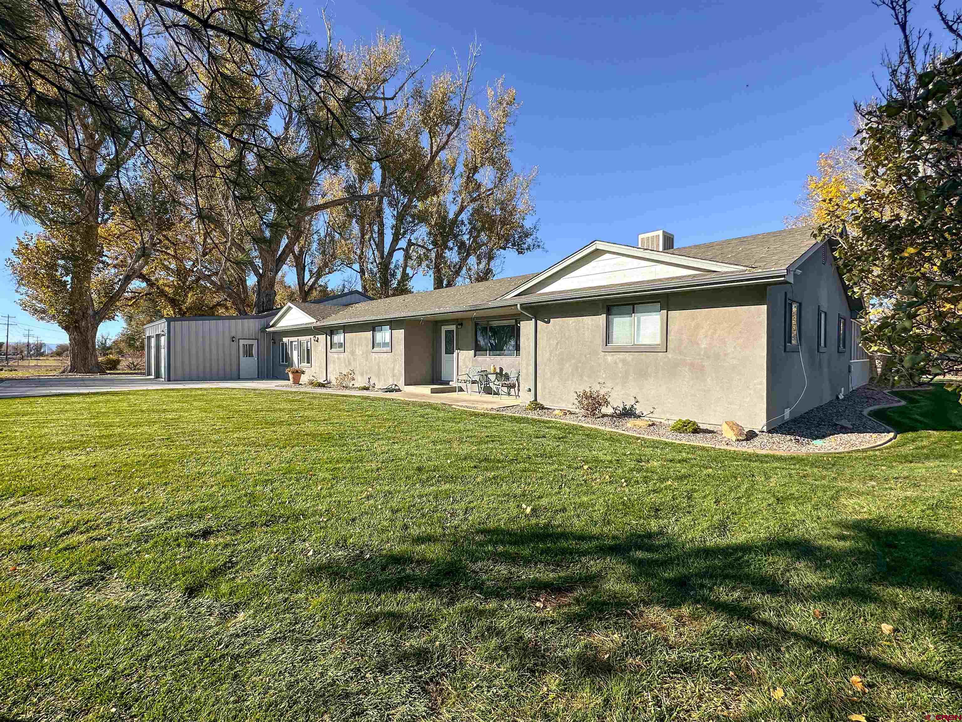 18555 F Road Delta, CO 81416 - Photo 36 of 43 a front view of a house with a garden