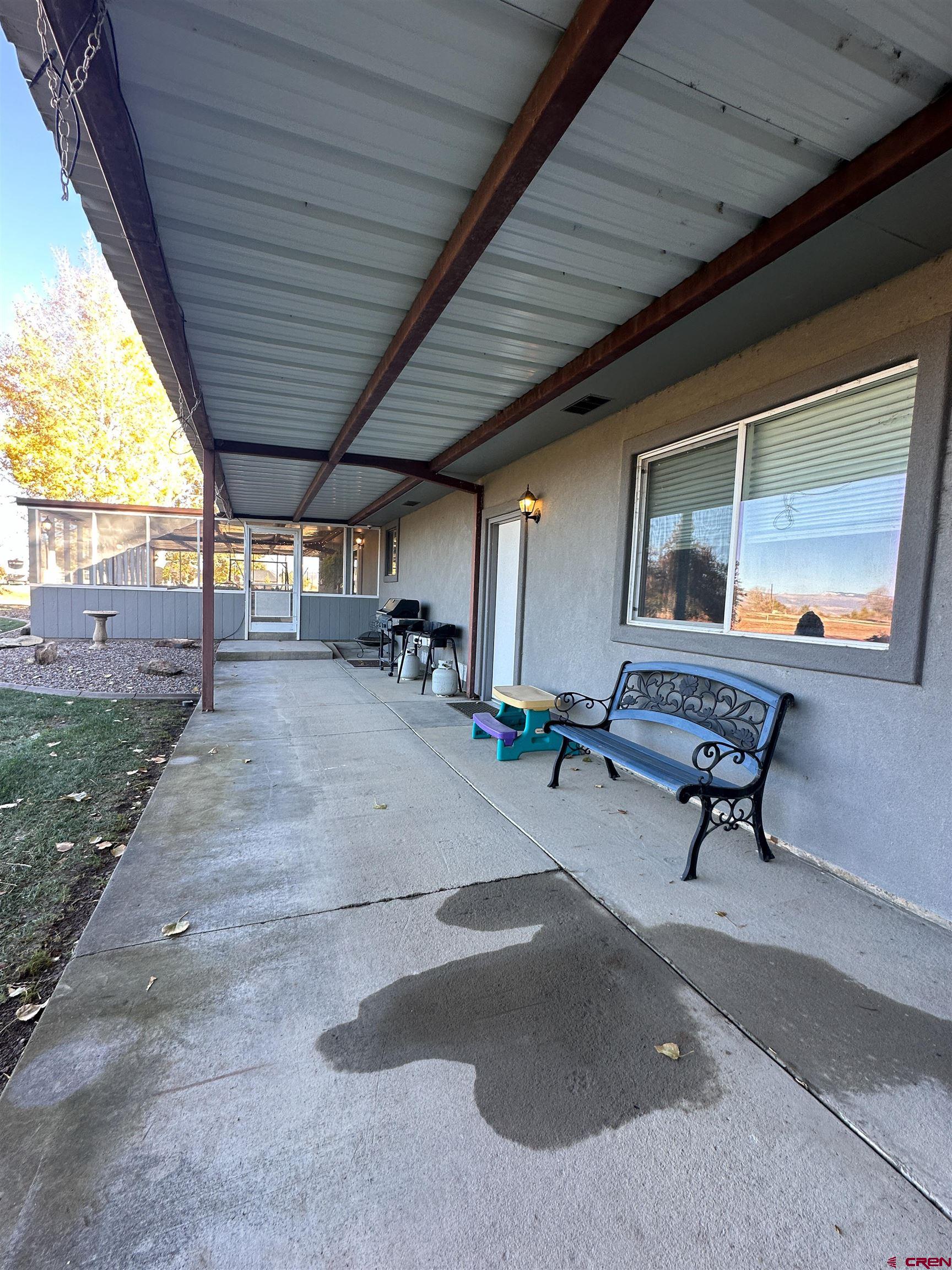 18555 F Road Delta, CO 81416 - Photo 39 of 43 a living room with patio furniture and a garden