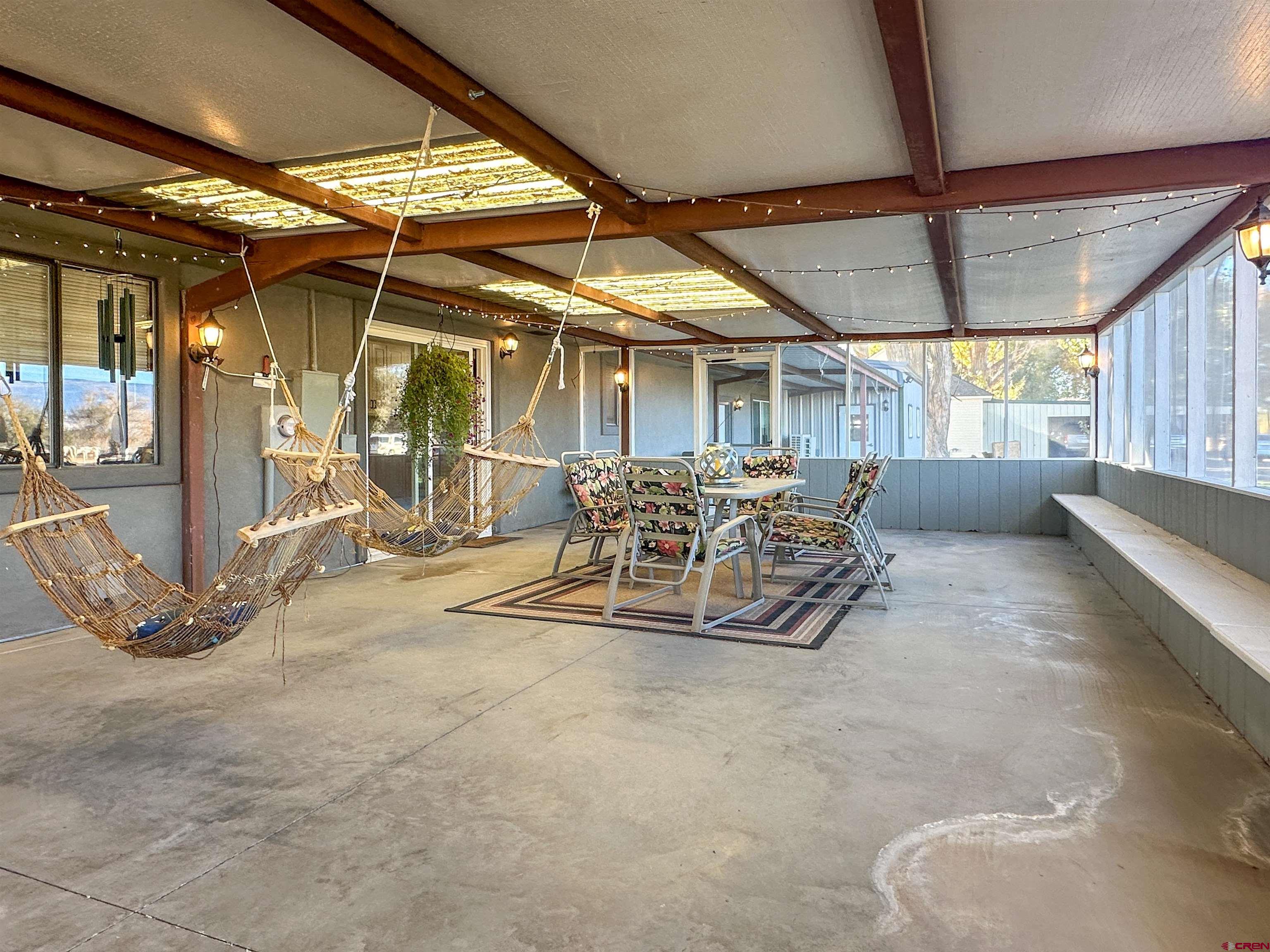 18555 F Road Delta, CO 81416 - Photo 41 of 43 a room with lots of furniture and a chandelier