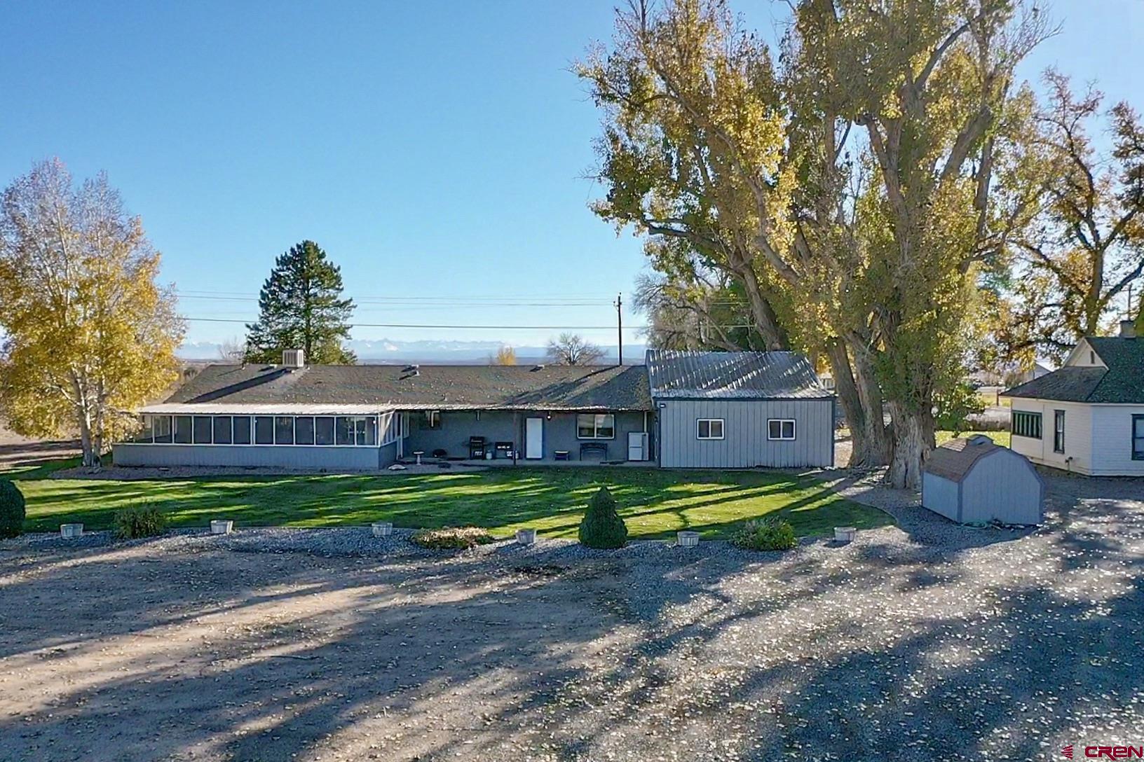 18555 F Road Delta, CO 81416 - Photo 43 of 43 a front view of a house with a yard and large trees