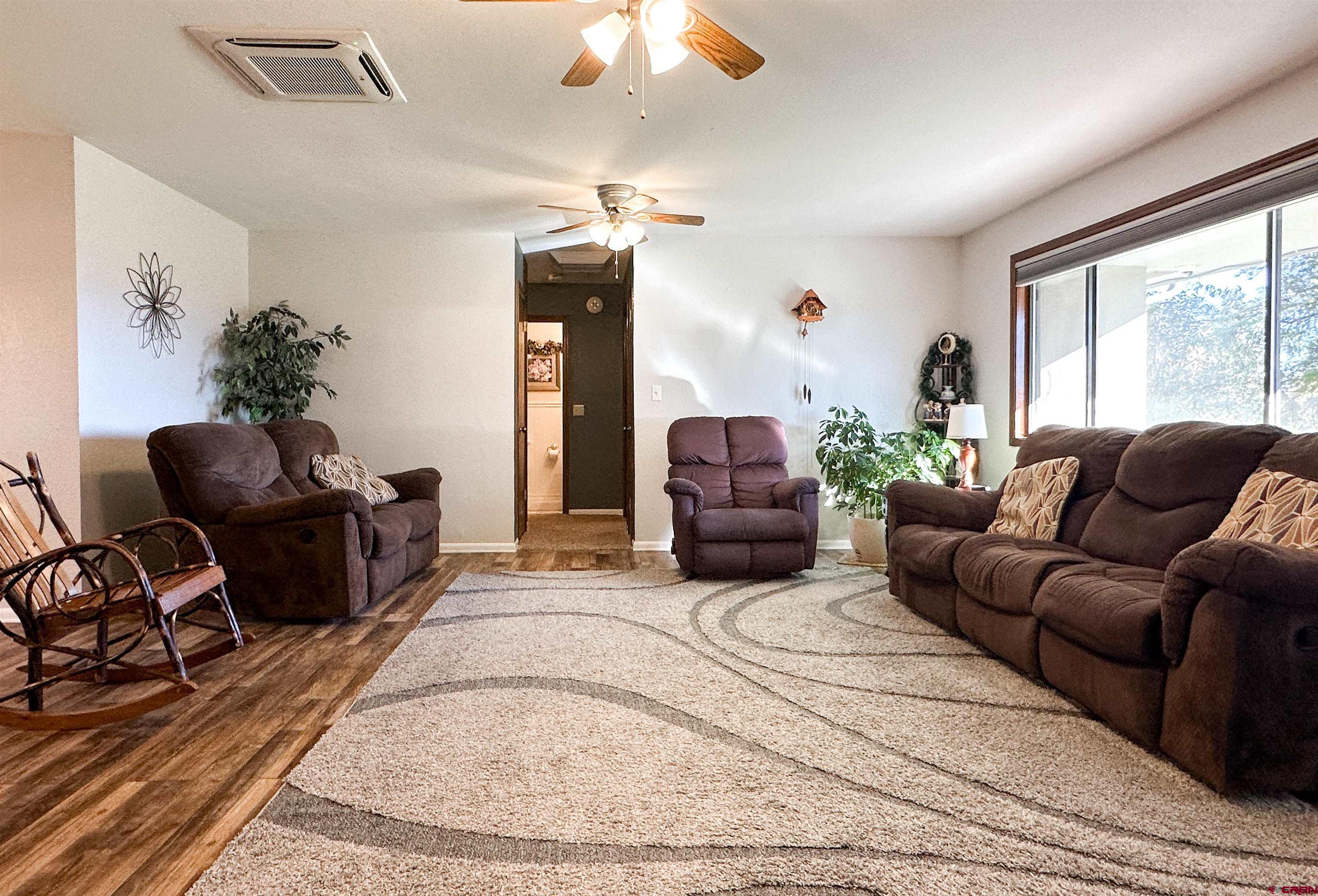 18555 F Road Delta, CO 81416 - Photo 7 of 43 a living room with furniture a flat screen tv and a large window
