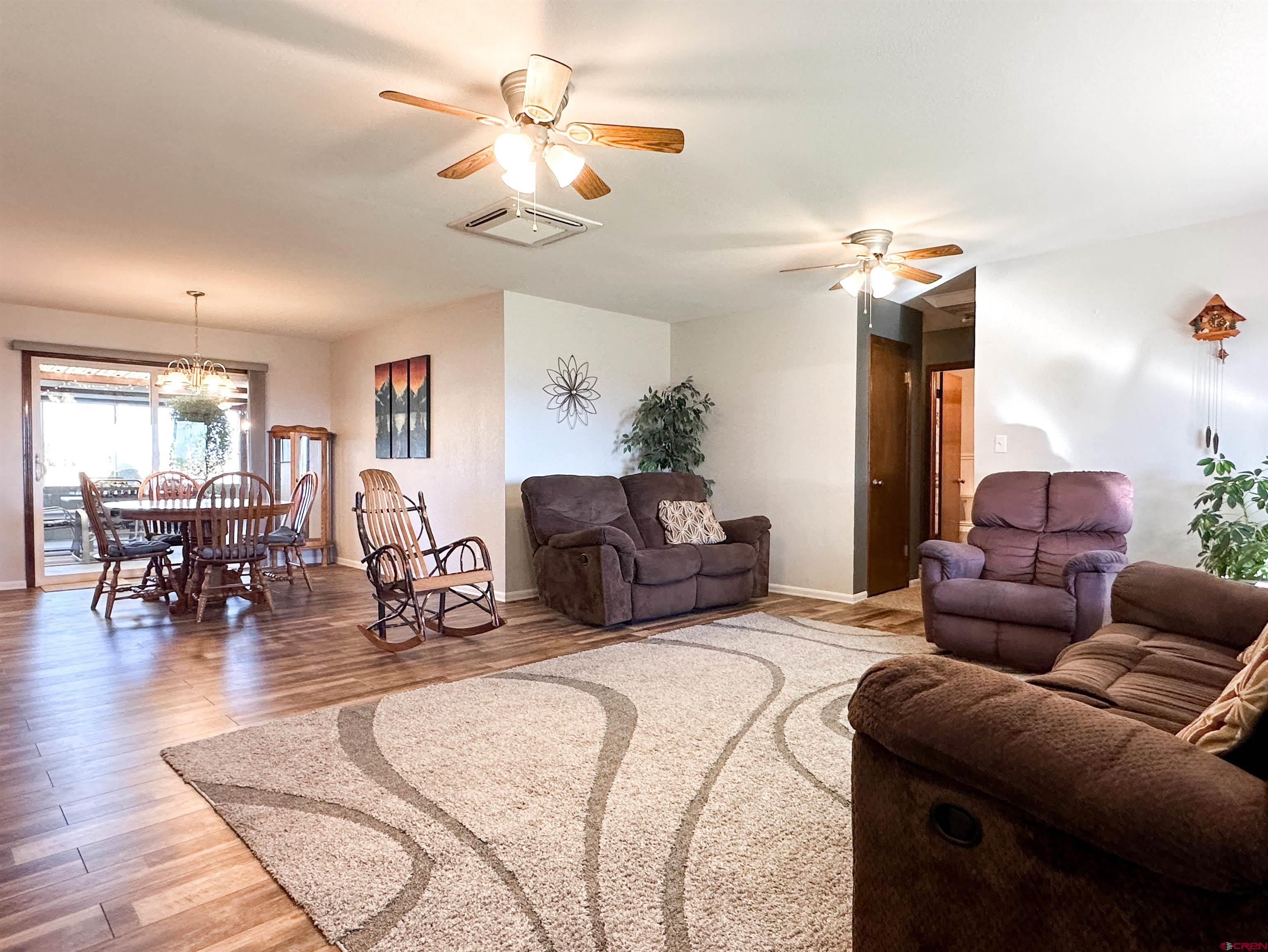 18555 F Road Delta, CO 81416 - Photo 8 of 43 a large bedroom with furniture a bed and a chandelier