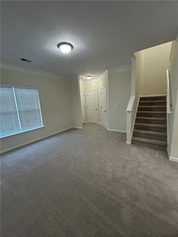 a view of an empty room with stairs