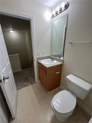a bathroom with a sink a toilet a mirror and vanity