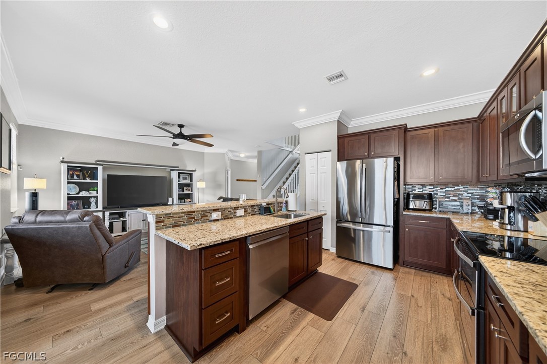 8313 Sumner Avenue Fort Myers, FL 33908 - Photo 11 of 42 a kitchen with stainless steel appliances granite countertop a stove oven and refrigerator
