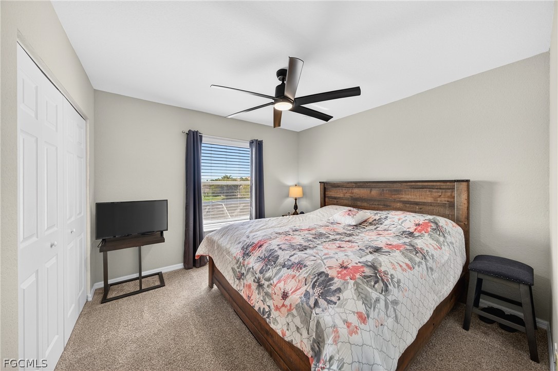 8313 Sumner Avenue Fort Myers, FL 33908 - Photo 25 of 42 a bedroom with a bed and a flat tv screen on the dresser
