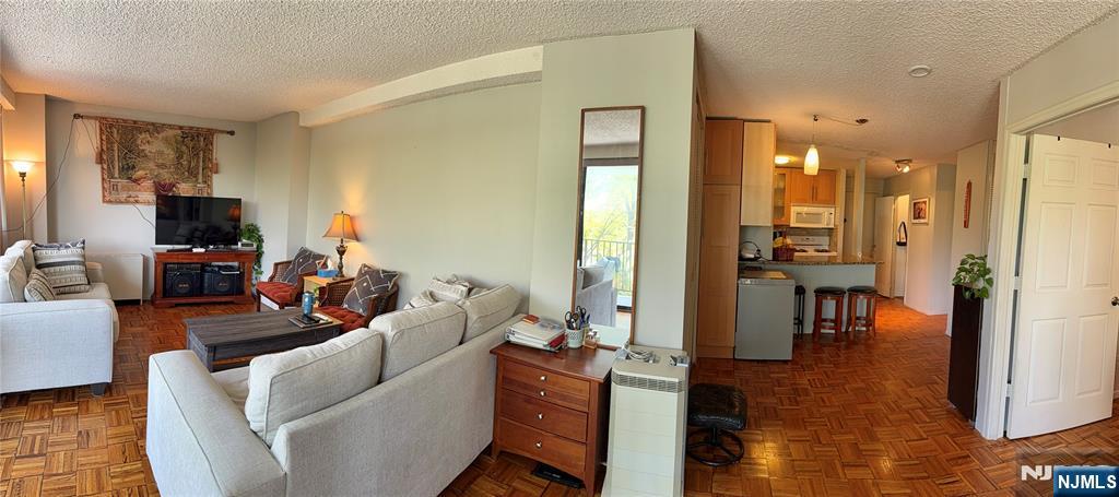 277 Prospect Avenue, Unit 4H Hackensack, NJ 07601 - Photo 4 of 19 a living room with furniture and a flat screen tv