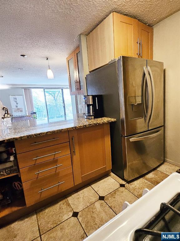 277 Prospect Avenue, Unit 4H Hackensack, NJ 07601 - Photo 8 of 19 a kitchen with stainless steel appliances a refrigerator and a stove