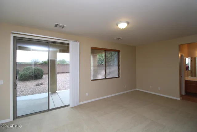 an empty room with sliding glass door and shower