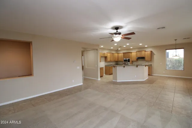 a view of a livingroom with a kitchen stove cabinets and a kitchen