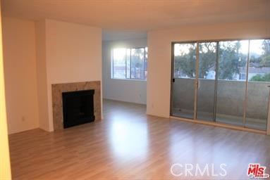 3111 4th Street, Unit 309 Santa Monica, CA 90405 - Photo 10 of 10 an empty room with wooden floor and a fireplace