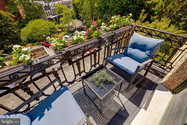 a view of a chairs and table in the balcony