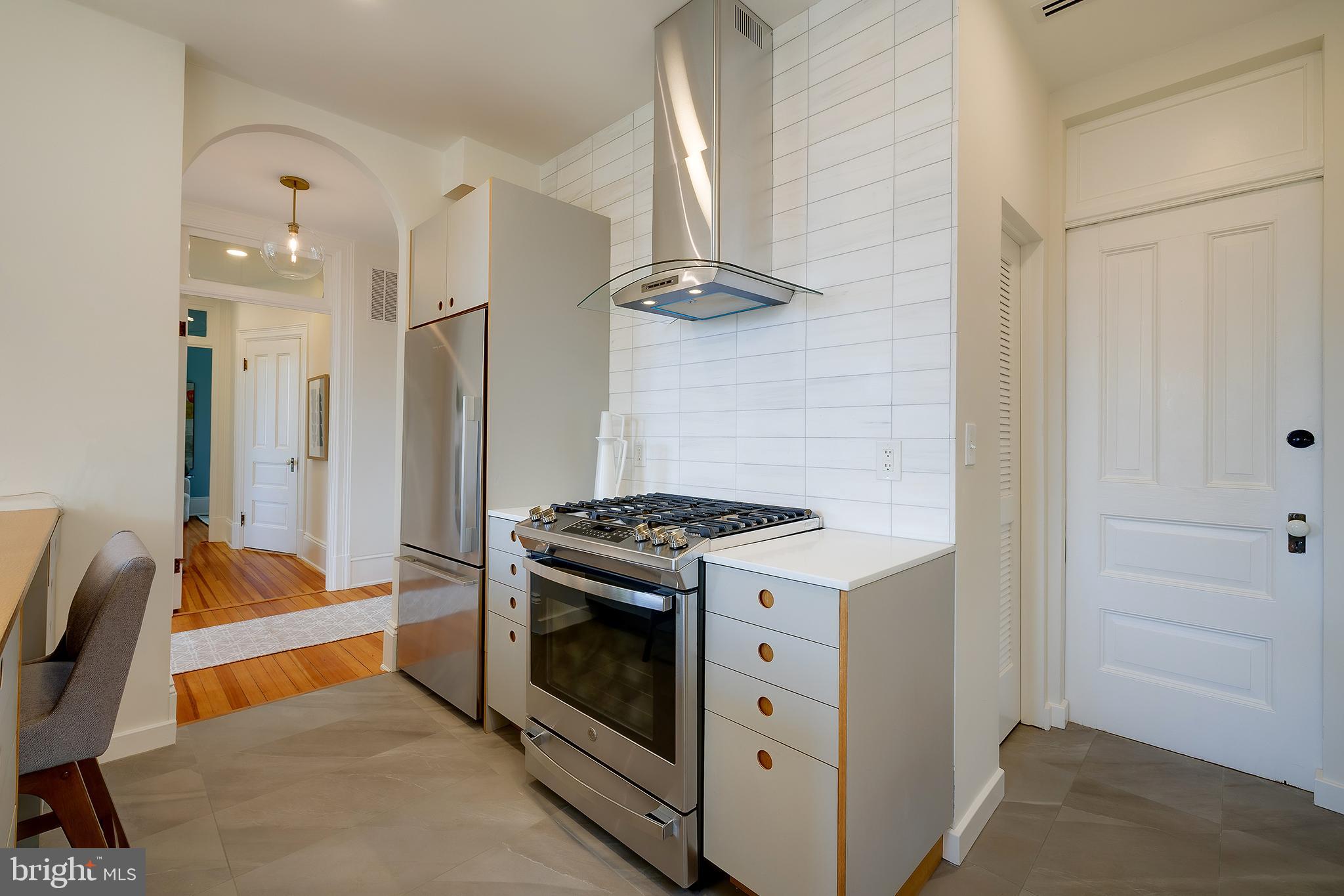 2853 Ontario Road Northwest, Unit 316 Washington, DC 20009 - Photo 12 of 42 a kitchen that has a stove and a refrigerator