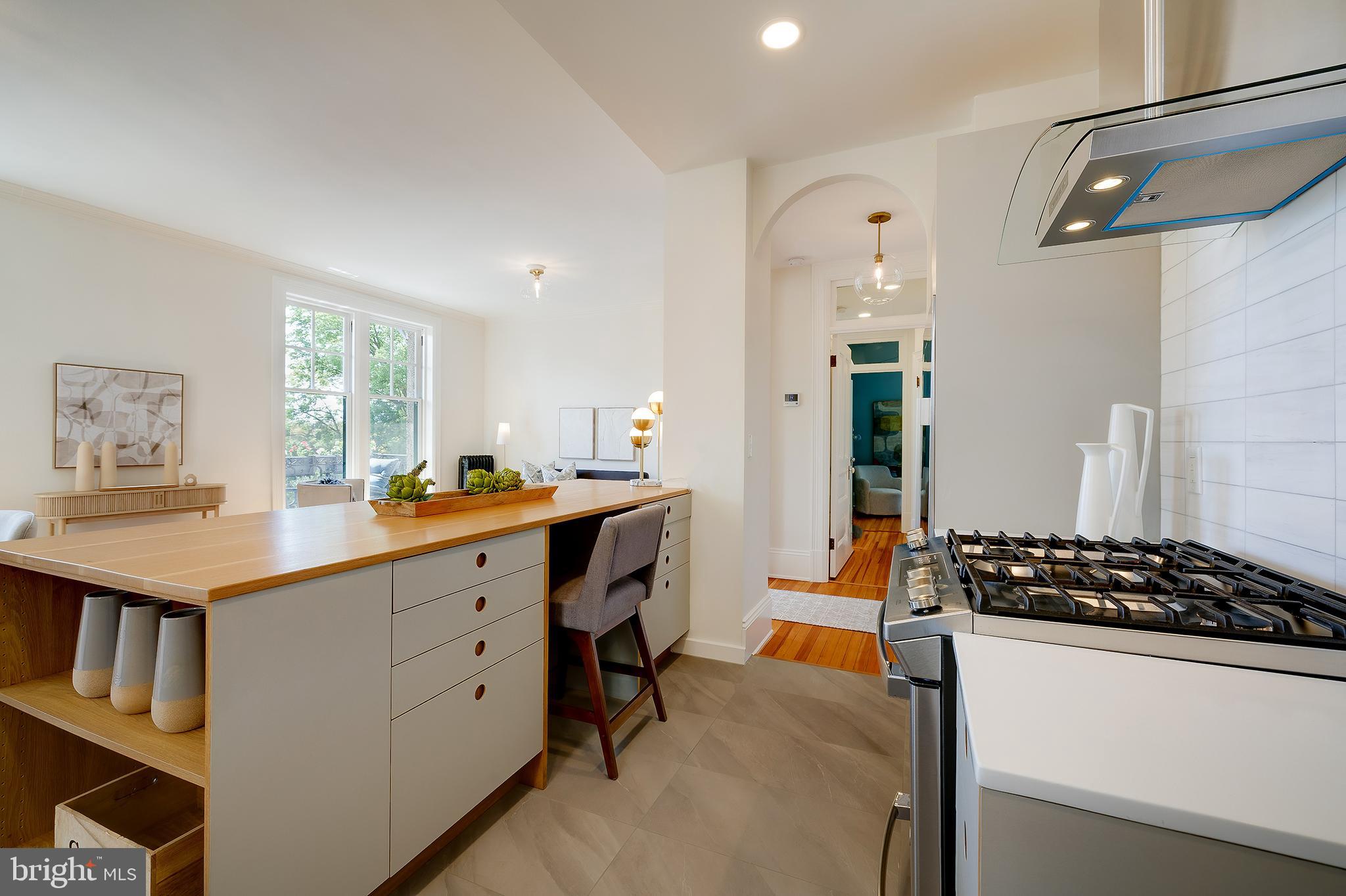 2853 Ontario Road Northwest, Unit 316 Washington, DC 20009 - Photo 13 of 42 a kitchen with a sink stove and cabinets