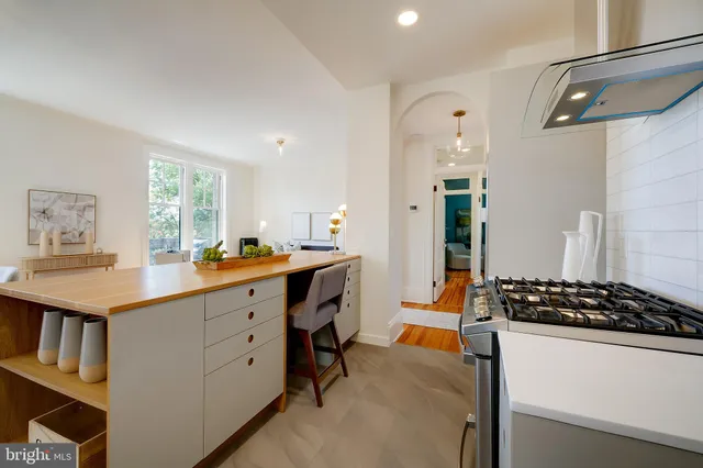 a kitchen with a sink stove and cabinets