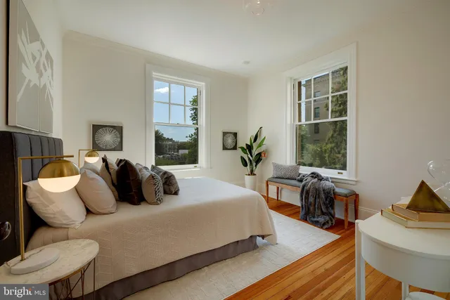 a bedroom with bed and wooden floor