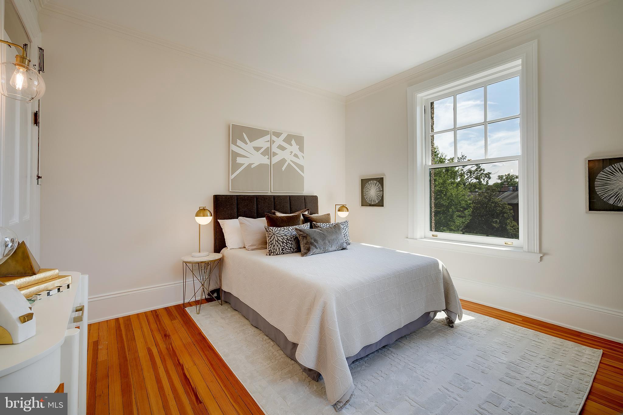 2853 Ontario Road Northwest, Unit 316 Washington, DC 20009 - Photo 16 of 42 a bedroom with a bed and wooden floor