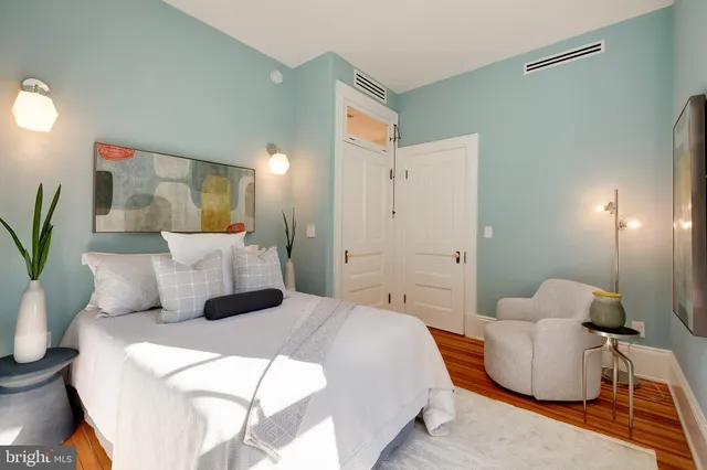 a bedroom with a bed and a couch