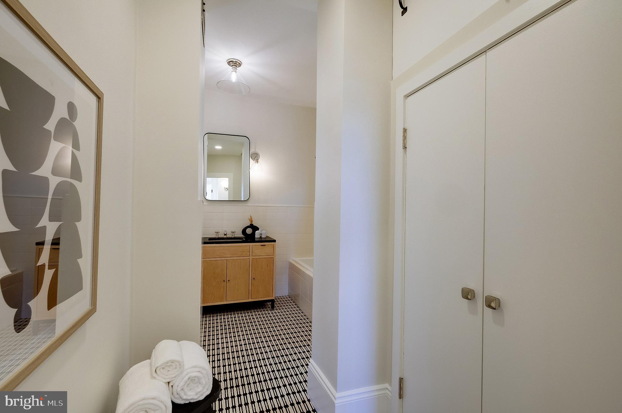 2853 Ontario Road Northwest, Unit 316 Washington, DC 20009 - Photo 21 of 42 a bathroom with a sink and a mirror