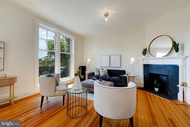 a living room with furniture a window and a fireplace