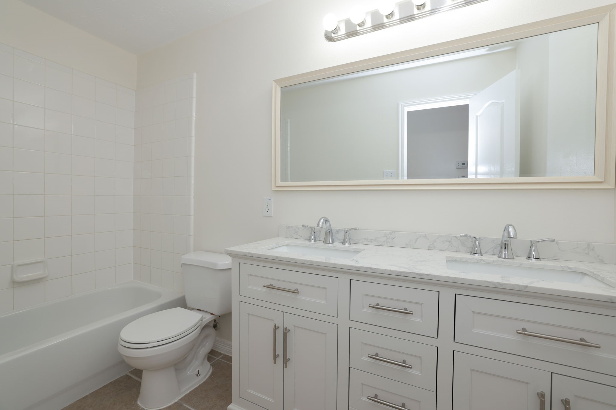 3031 Country Boy Court Spring, TX 77373 - Photo 27 of 35 a bathroom with a granite countertop toilet sink and mirror