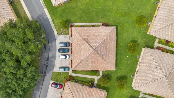 an aerial view of a house with a yard and potted plants