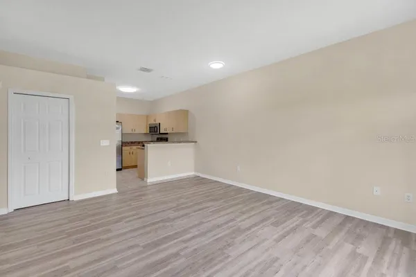 a view of a kitchen with a sink and wooden floor