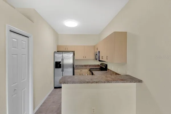 a kitchen with granite countertop a sink and a stove top oven